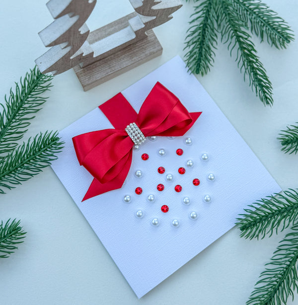 Elegant Handmade Christmas Card with Red Bow and Gem Ornament Design
