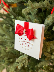 Elegant Handmade Christmas Card with Red Bow and Gem Ornament Design