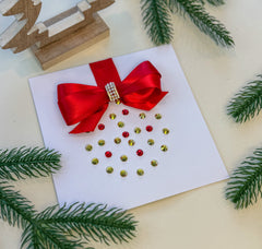 Elegant Handmade Christmas Card with Red Bow and Gem Ornament Design