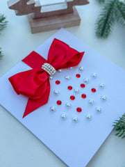 Elegant Handmade Christmas Card with Red Bow and Gem Ornament Design
