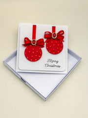 Elegant Handmade Christmas Card with Red Bow and Gem Ornament Design