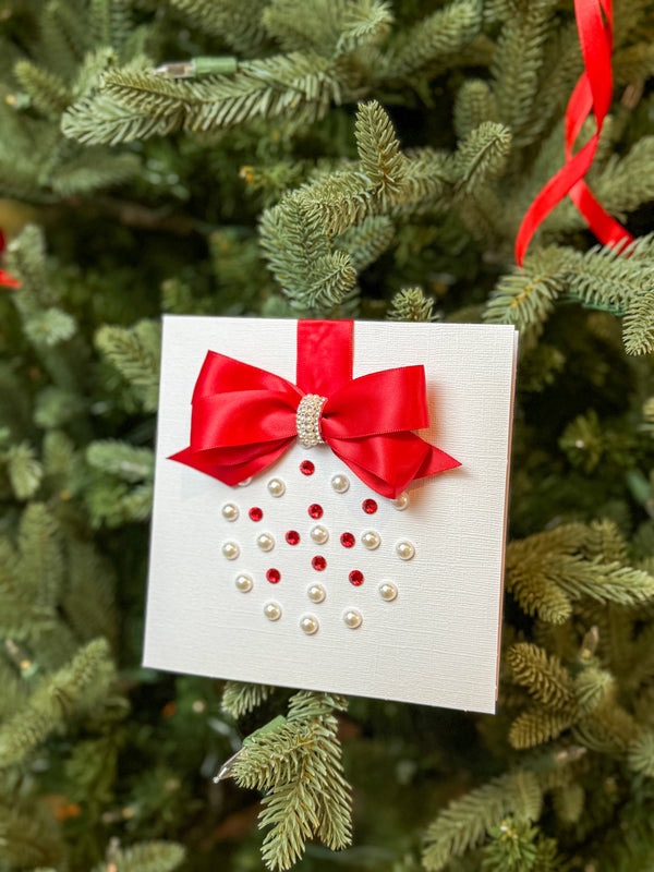 Elegant Handmade Christmas Card with Red Bow and Gem Ornament Design