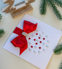 Elegant Handmade Christmas Card with Red Bow and Gem Ornament Design