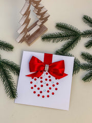 Elegant Handmade Christmas Card with Red Bow and Gem Ornament Design