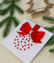 Elegant Handmade Christmas Card with Red Bow and Gem Ornament Design