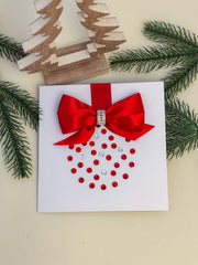 Elegant Handmade Christmas Card with Red Bow and Gem Ornament Design